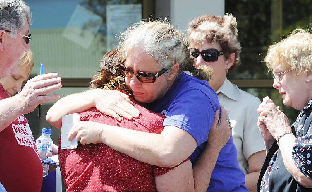 Health workers console each other after six employees lost their jobs at Maryborough Hospital. Health workers console each other after six employees lost their jobs at Maryborough Hospital.